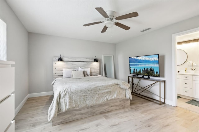 bedroom featuring ceiling fan, ensuite bathroom, and light hardwood / wood-style flooring