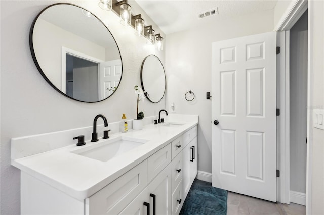 bathroom with vanity and tile patterned flooring