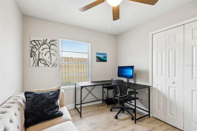 office area with light hardwood / wood-style floors and ceiling fan