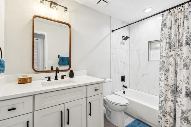 full bathroom with vanity, shower / bath combo with shower curtain, and toilet