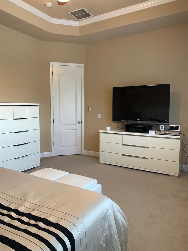 bedroom featuring visible vents, light carpet, baseboards, crown molding, and a raised ceiling
