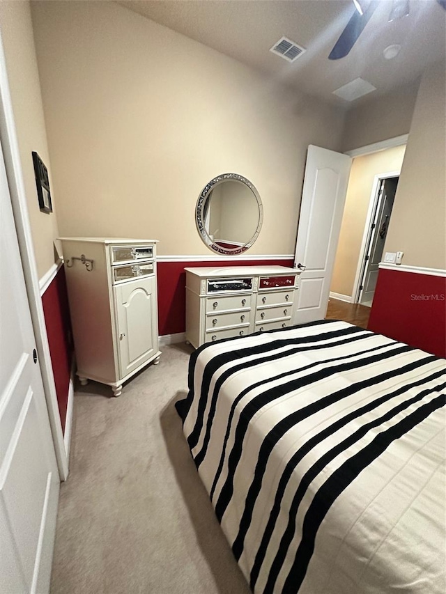 bedroom with visible vents and light colored carpet