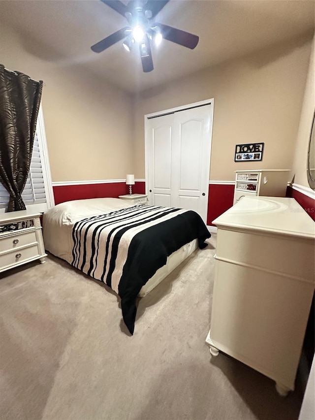 bedroom with a closet, carpet floors, and a ceiling fan