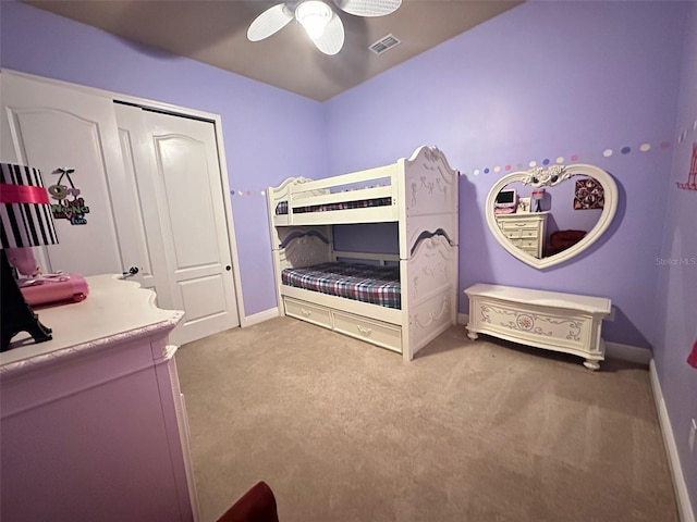 bedroom featuring visible vents, baseboards, ceiling fan, light colored carpet, and a closet