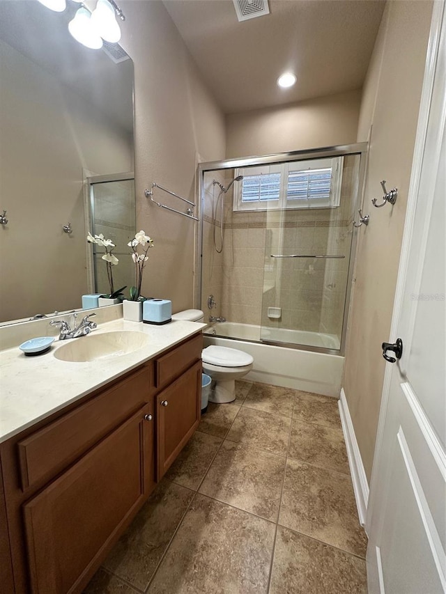 full bathroom featuring visible vents, baseboards, bath / shower combo with glass door, toilet, and vanity