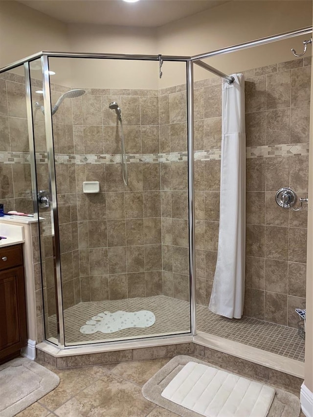 full bathroom with vanity and a stall shower