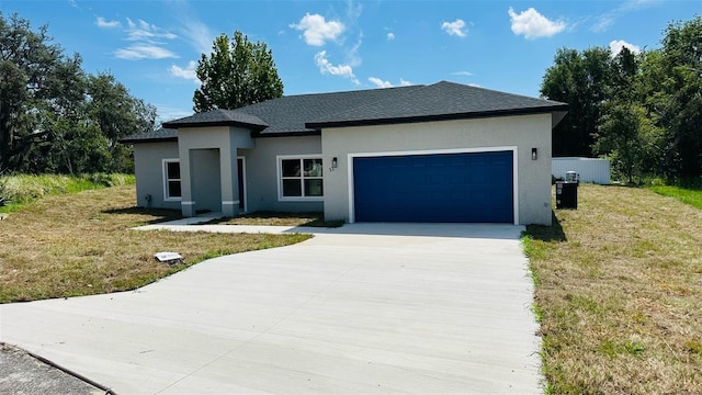11 Spruce Ln, Ocala, FL 34472 - prairie-style home featuring concrete driveway, an attached garage, stucco siding, a front lawn, and a shingled roof