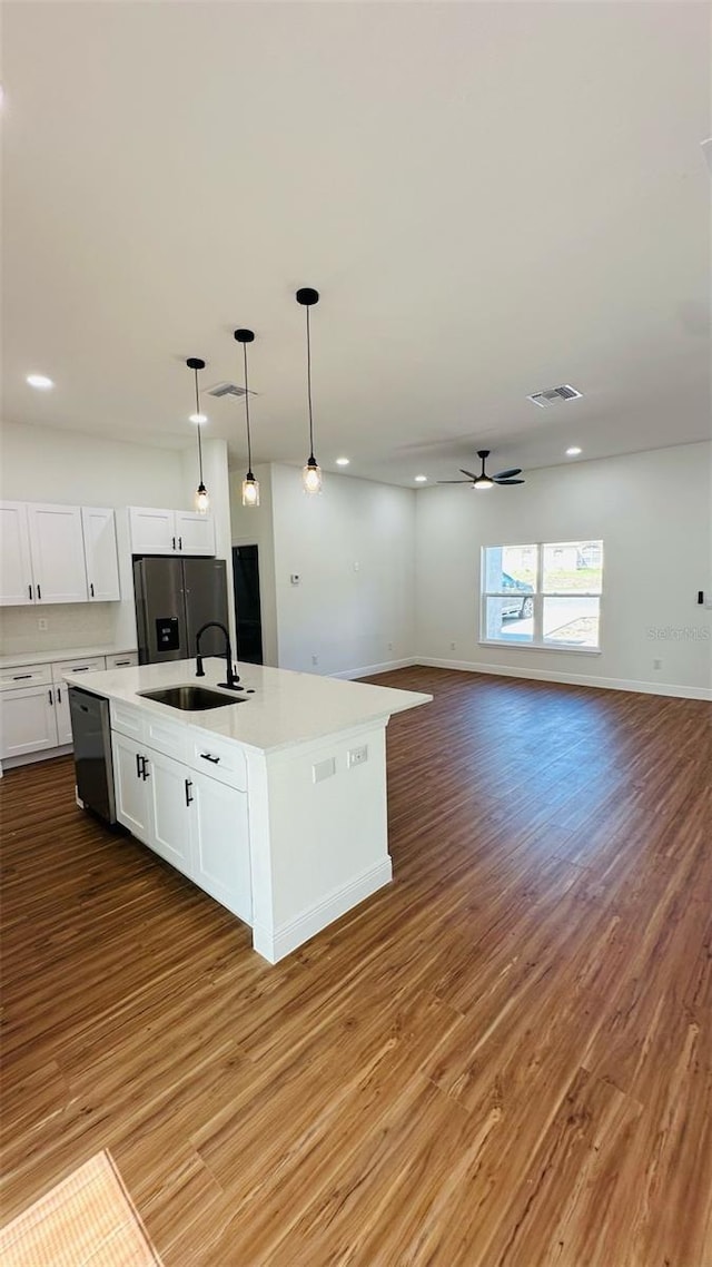 11 Spruce Ln, Ocala, FL 34472 - kitchen featuring appliances with stainless steel finishes, white cabinetry, wood finished floors, light countertops, and recessed lighting