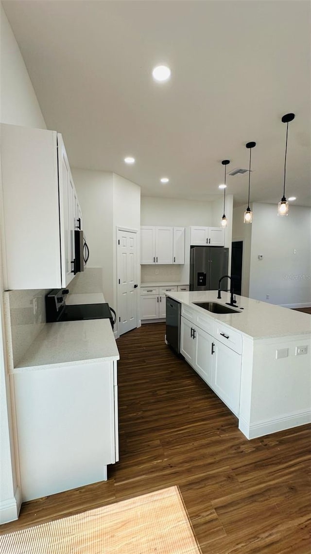 11 Spruce Ln, Ocala, FL 34472 - kitchen with appliances with stainless steel finishes, white cabinetry, dark wood-style flooring, a center island with sink, and light countertops