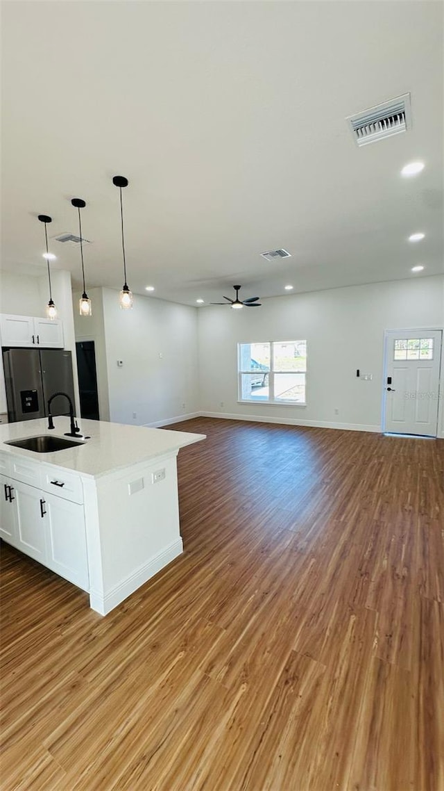 11 Spruce Ln, Ocala, FL 34472 - kitchen featuring fridge with ice dispenser, light wood-style flooring, open floor plan, white cabinets, and recessed lighting