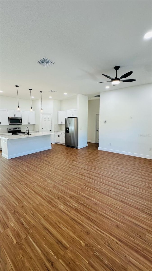11 Spruce Ln, Ocala, FL 34472 - unfurnished living room featuring wood finished floors, recessed lighting, and a ceiling fan