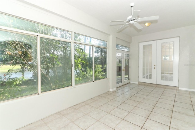 unfurnished sunroom with plenty of natural light, french doors, and ceiling fan