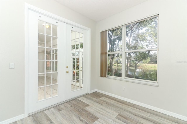 doorway to outside featuring french doors and light hardwood / wood-style flooring