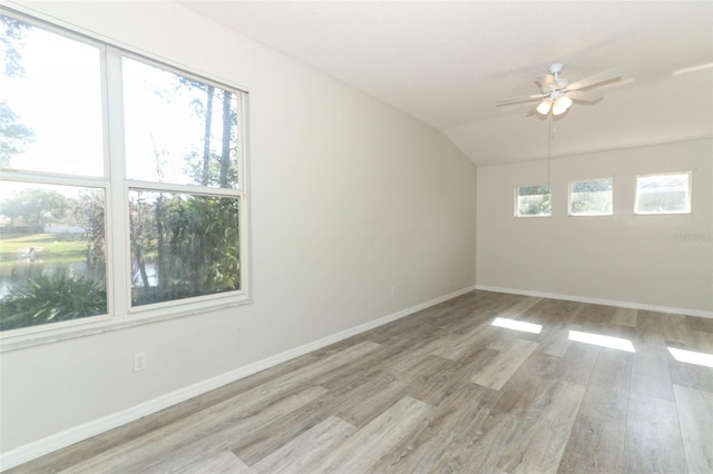 unfurnished room featuring vaulted ceiling, ceiling fan, and light wood-type flooring