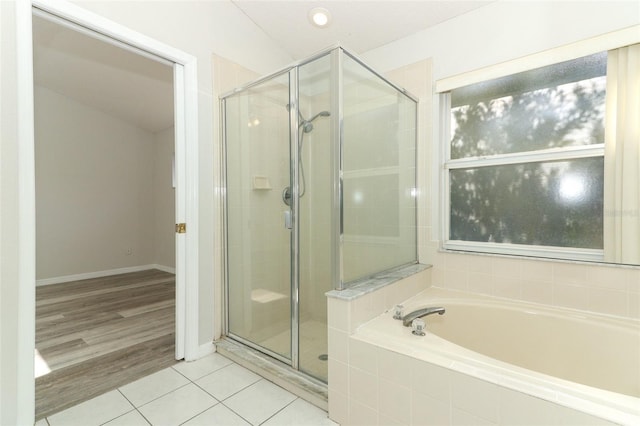 bathroom with tile patterned floors and independent shower and bath