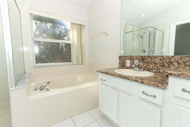 bathroom featuring vanity, shower with separate bathtub, and tile patterned flooring