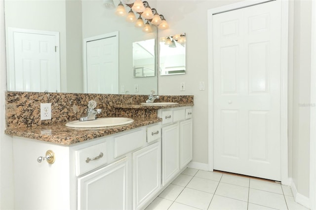 bathroom with decorative backsplash, tile patterned floors, and vanity