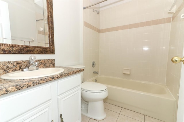 full bathroom featuring tile patterned flooring, vanity, tiled shower / bath combo, and toilet