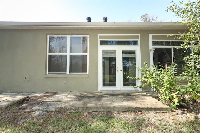 entrance to property featuring a patio and french doors