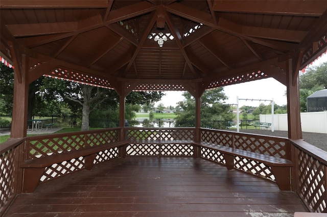 deck with a gazebo and a water view