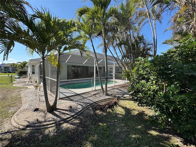 view of swimming pool with a lanai and a patio