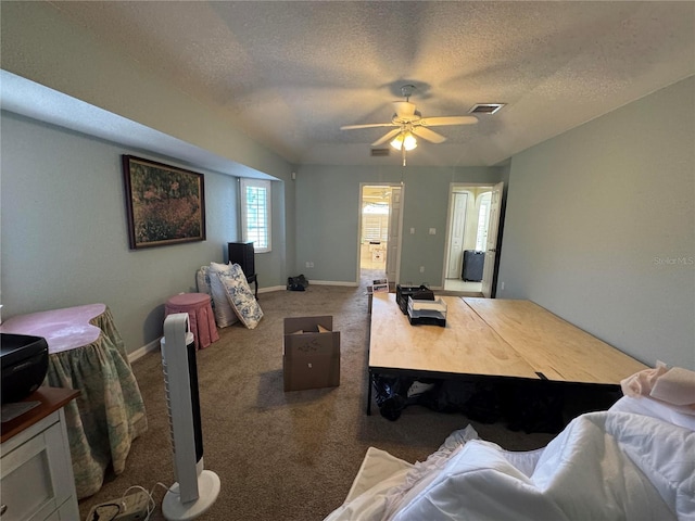 interior space with ceiling fan, carpet flooring, and a textured ceiling