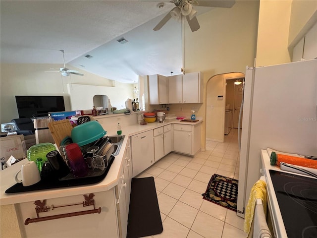 kitchen with vaulted ceiling, white cabinetry, light tile patterned floors, ceiling fan, and kitchen peninsula