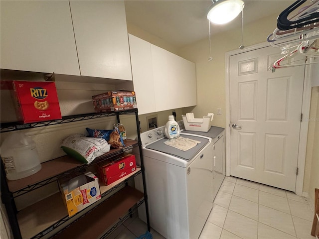 laundry room featuring light tile patterned floors, cabinets, and washing machine and clothes dryer