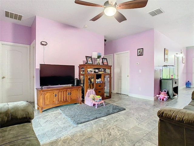 living area featuring a ceiling fan, visible vents, and baseboards