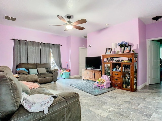 living area with visible vents, ceiling fan, and baseboards