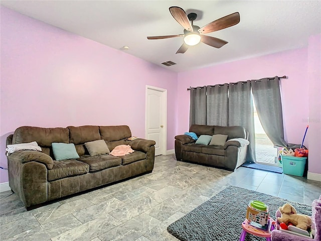 living area featuring visible vents, a ceiling fan, and baseboards