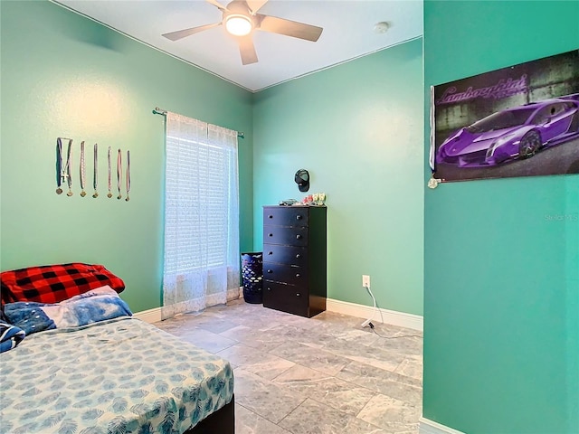 bedroom featuring a ceiling fan and baseboards