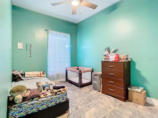 bedroom featuring a ceiling fan and baseboards