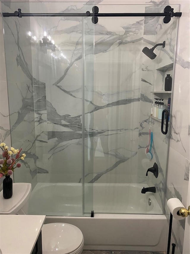 bathroom featuring shower / bath combination with glass door, vanity, and toilet