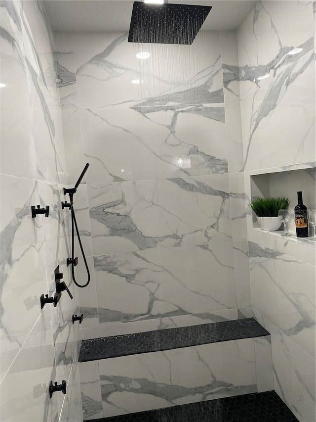 full bath with a marble finish shower