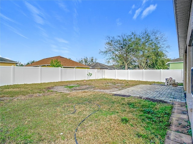 view of yard with a patio area and a fenced backyard