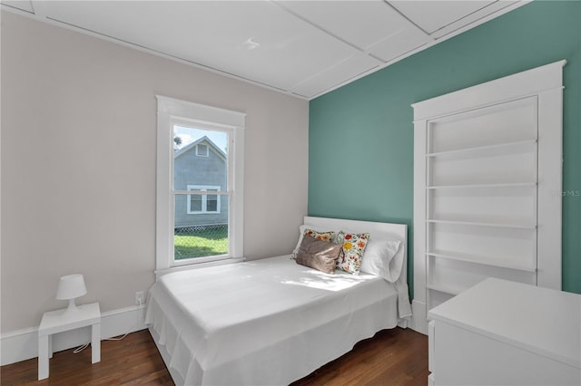 bedroom with dark wood-type flooring