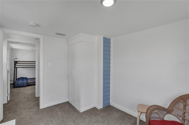 unfurnished bedroom with light colored carpet and a closet