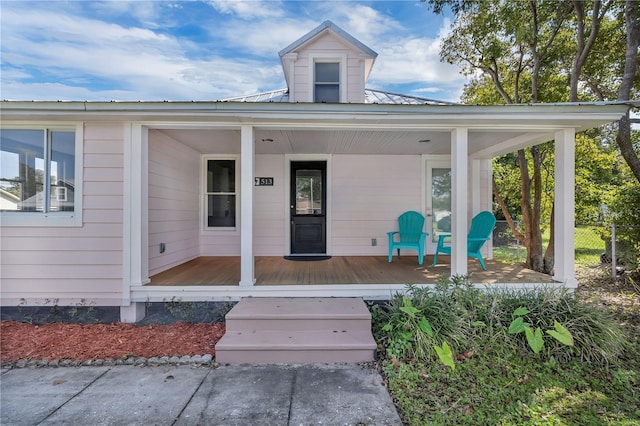 view of exterior entry with a porch