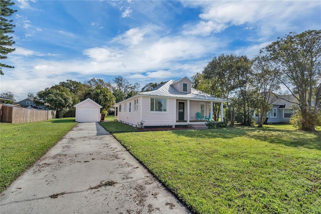 view of front of house featuring an outbuilding, a porch, a garage, and a front yard