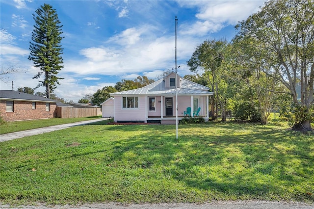 view of front of property with a garage, a front lawn, and a porch