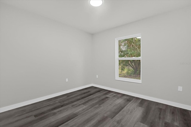 empty room featuring dark hardwood / wood-style flooring