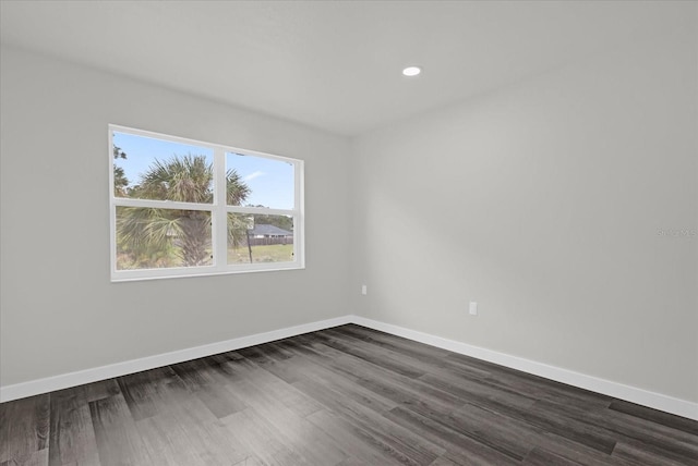 unfurnished room featuring dark hardwood / wood-style flooring