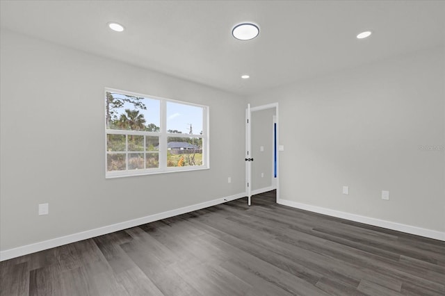 spare room featuring dark hardwood / wood-style flooring