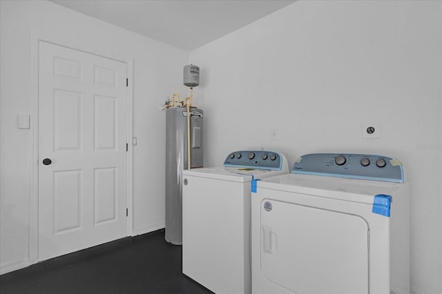 laundry area with electric water heater and washer and clothes dryer