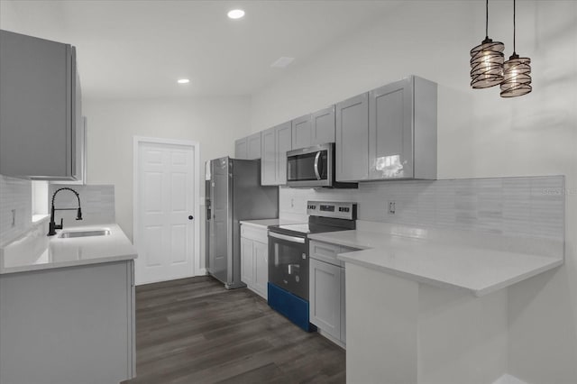 kitchen featuring pendant lighting, sink, stainless steel appliances, dark hardwood / wood-style flooring, and decorative backsplash