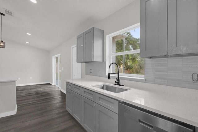 kitchen featuring dishwasher, sink, gray cabinetry, decorative backsplash, and hanging light fixtures