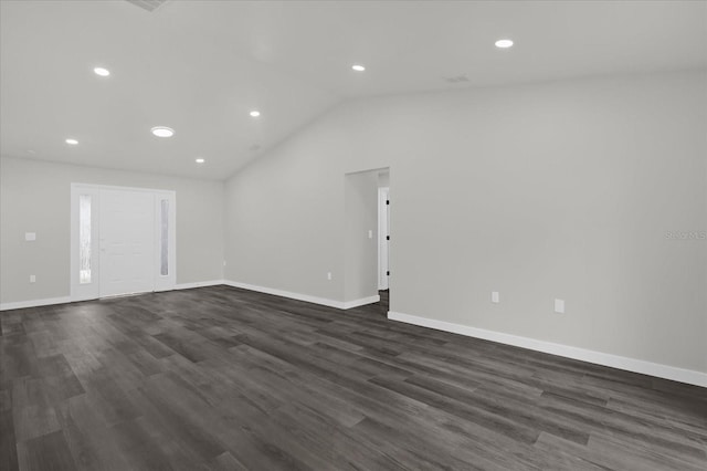 empty room with lofted ceiling and dark wood-type flooring