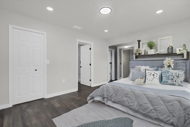 bedroom with dark hardwood / wood-style floors