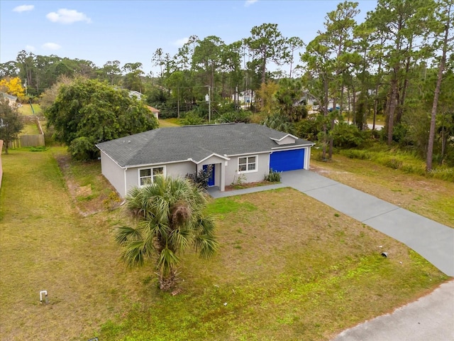 view of front of home with a garage and a front lawn